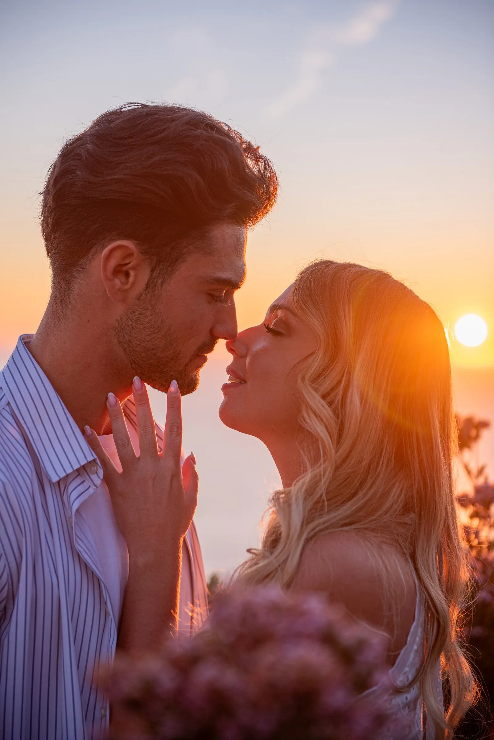 Séance couple dans les calanques au coucher du soleil : nez contre nez en contre-jour, prêts à s'embrasser